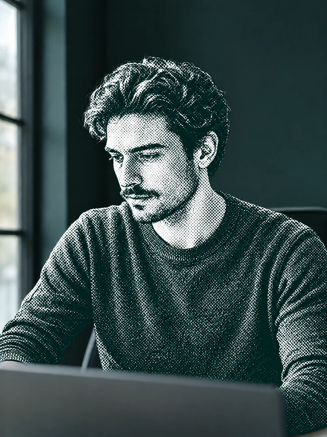 Person working on a laptop at a desk